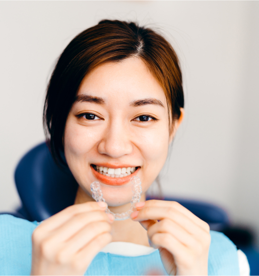 woman putting in clear aligner