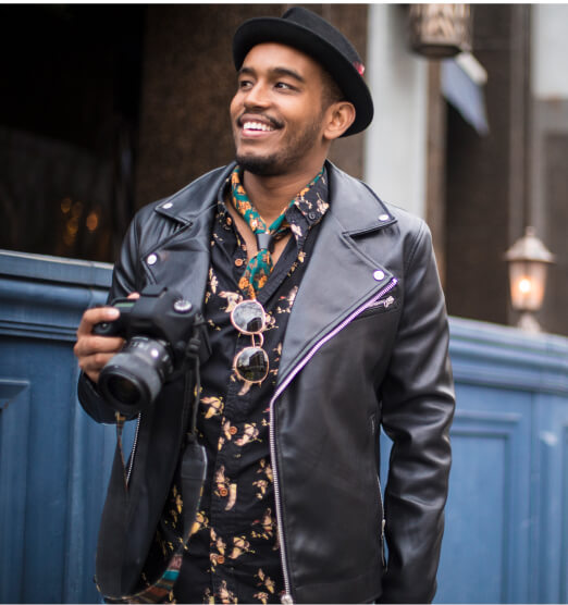 smiling man holding camera